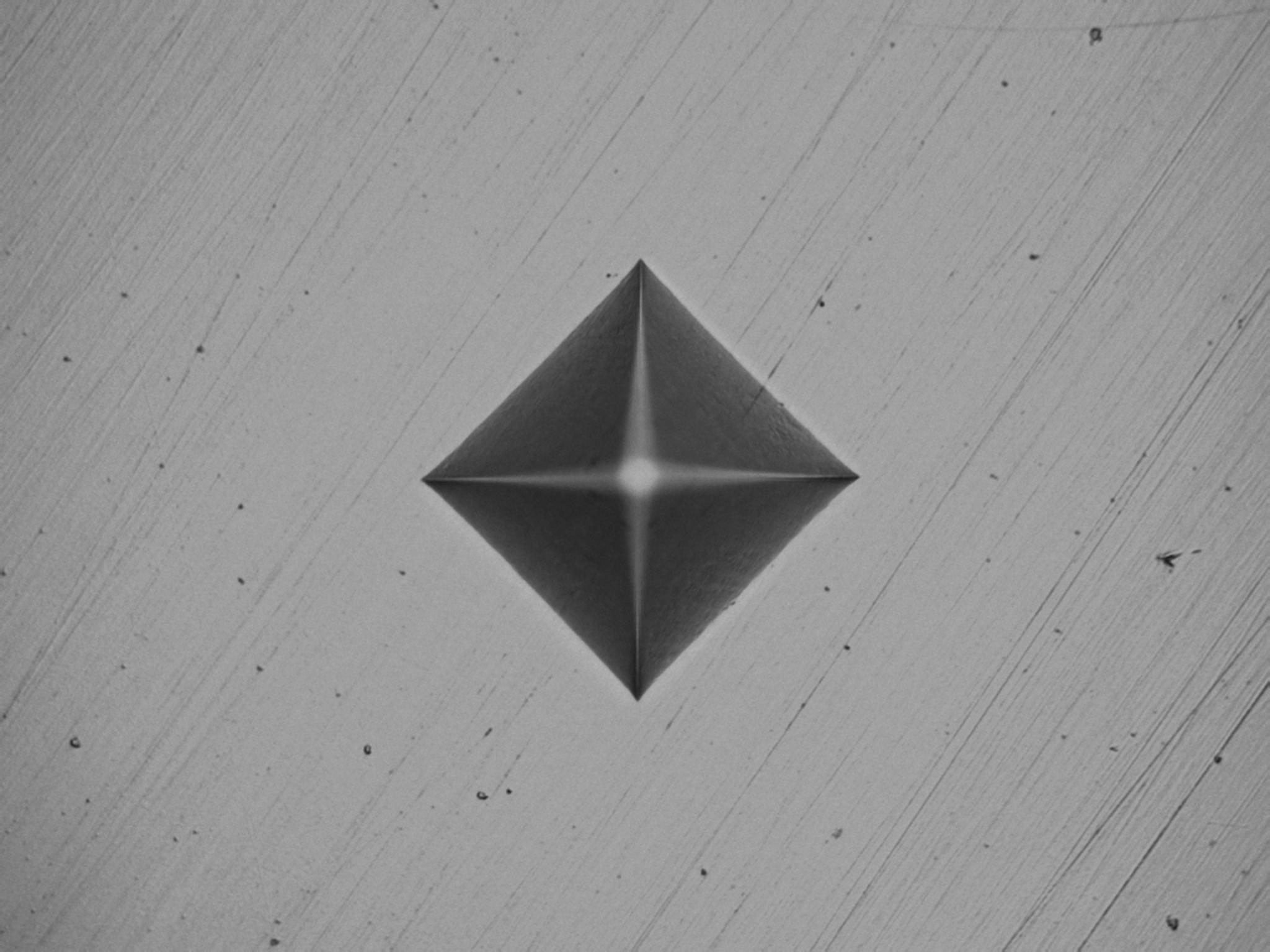 Vickers hardness test indentation on a metal sample