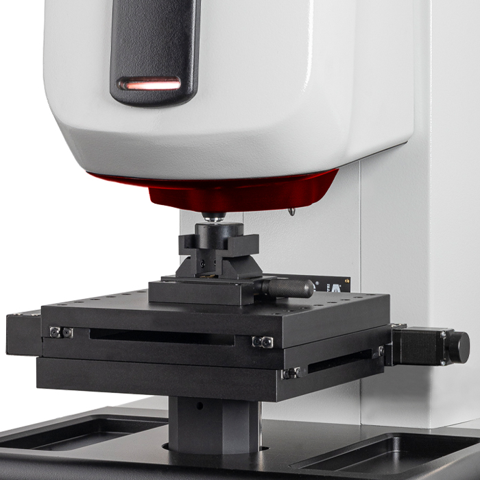 Close-up of a precision calibration machine with a focus on its sturdy metal platform and control mechanism.