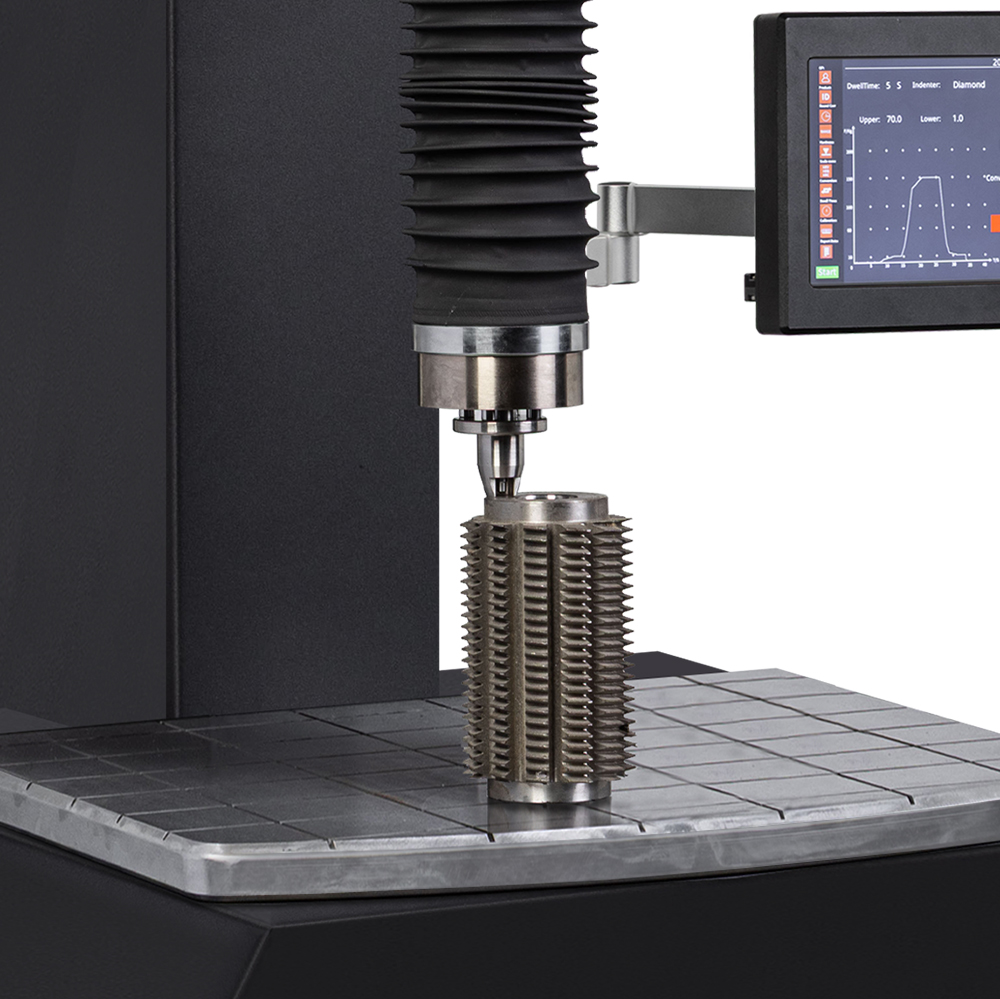 Industrial hardness testing machine with digital display analyzing metallic gear.