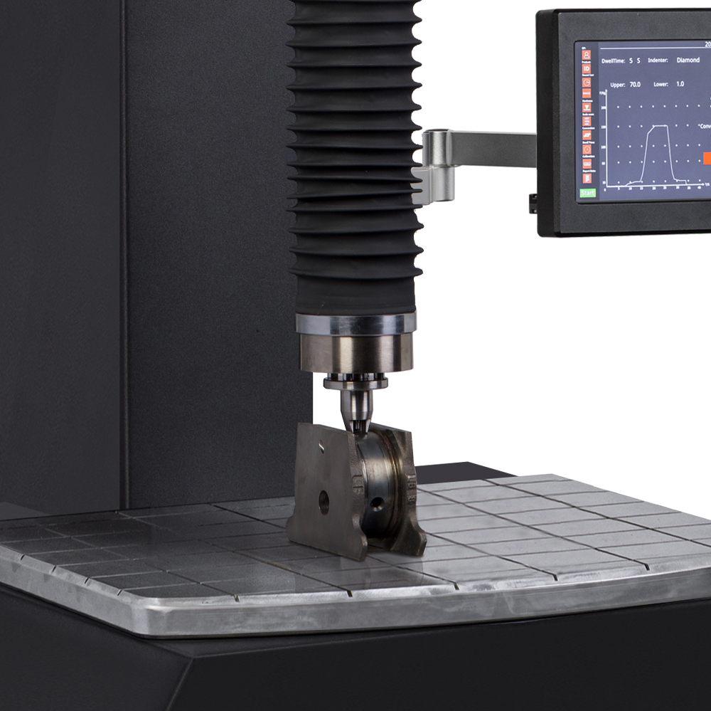 Precision testing machine with display analyzing a metal component for quality control in an industrial setting.