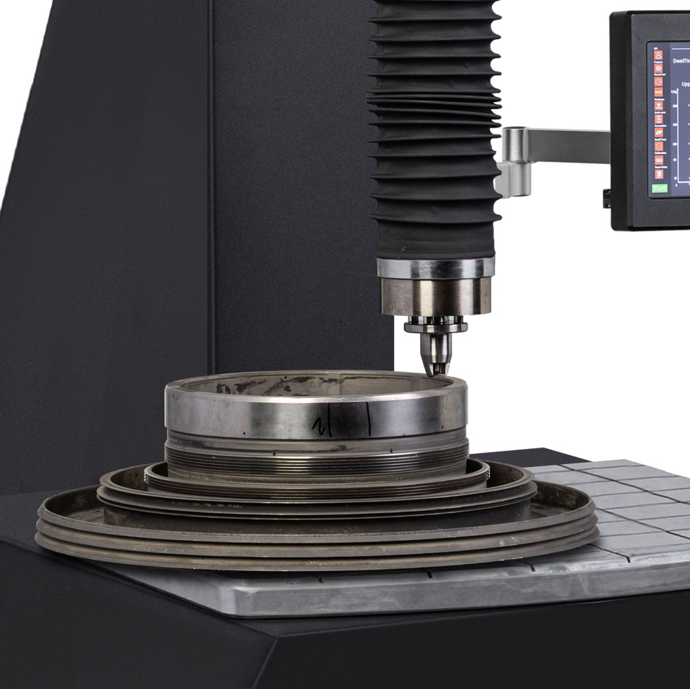 Industrial machine performing precision metalworking task.