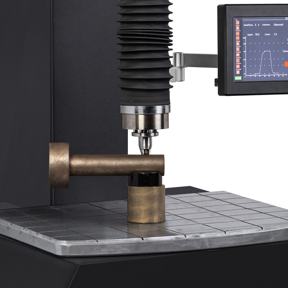 Industrial hardness tester examining a metal component with digital display readings, close-up view.
