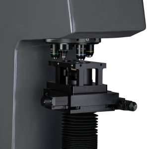 Close-up image of an advanced microscope, showcasing its multiple lenses and precision components.