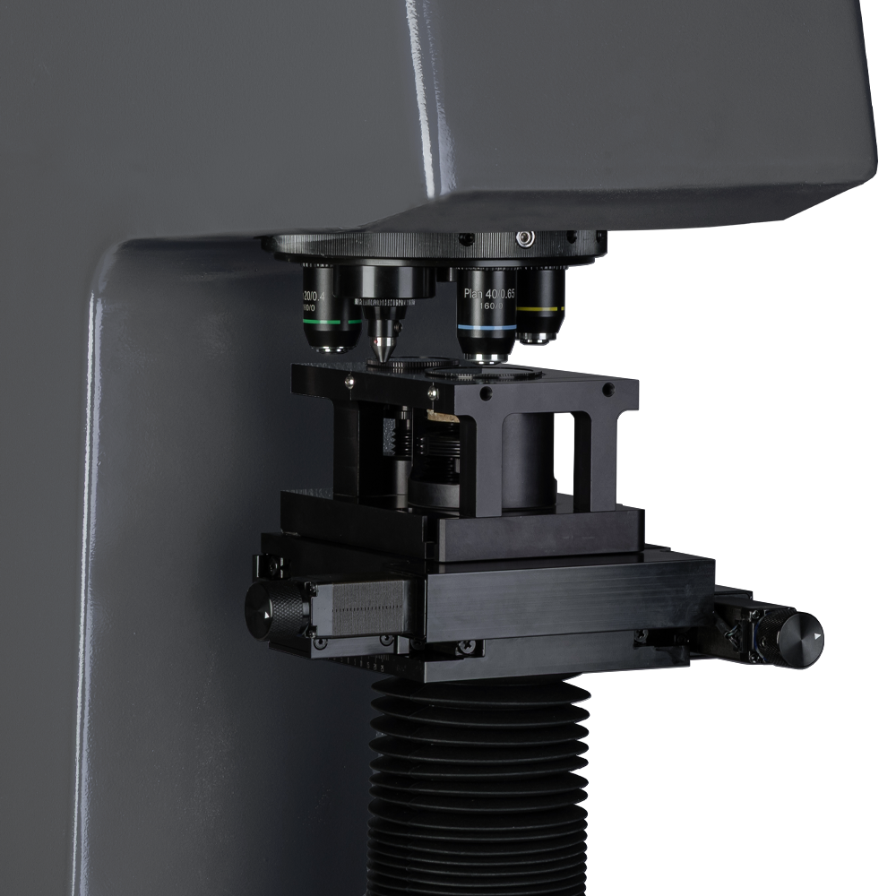 Close-up image of an advanced microscope, showcasing its multiple lenses and precision components.