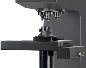 Close-up of a high-precision metallurgical microscope used for material analysis in a laboratory setting.