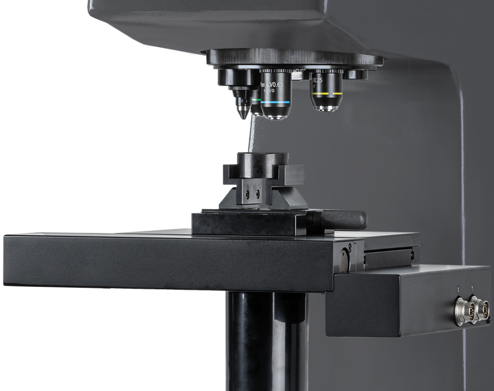 Close-up of a high-precision metallurgical microscope used for material analysis in a laboratory setting.