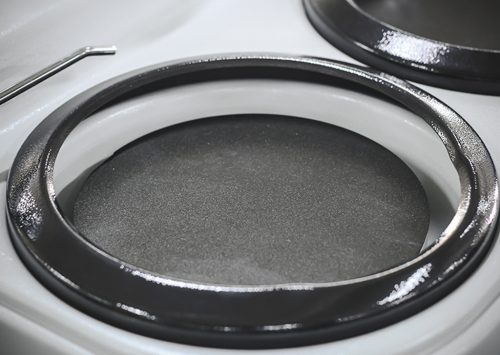 Close-up of a shiny black stovetop burner on a modern electric stove for kitchen appliances and cooking efficiency.